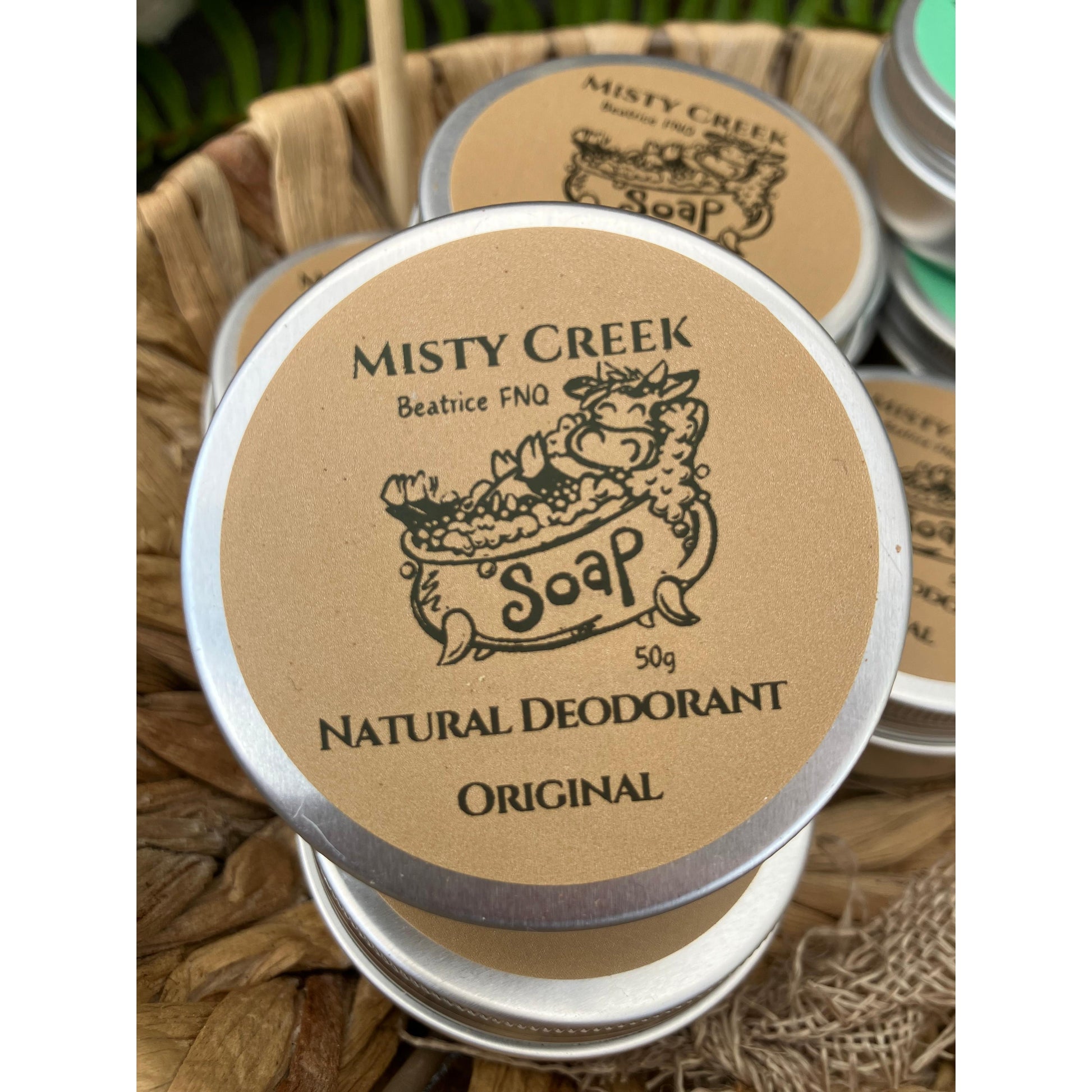 Misty Creek natural deodorant container on a woven surface