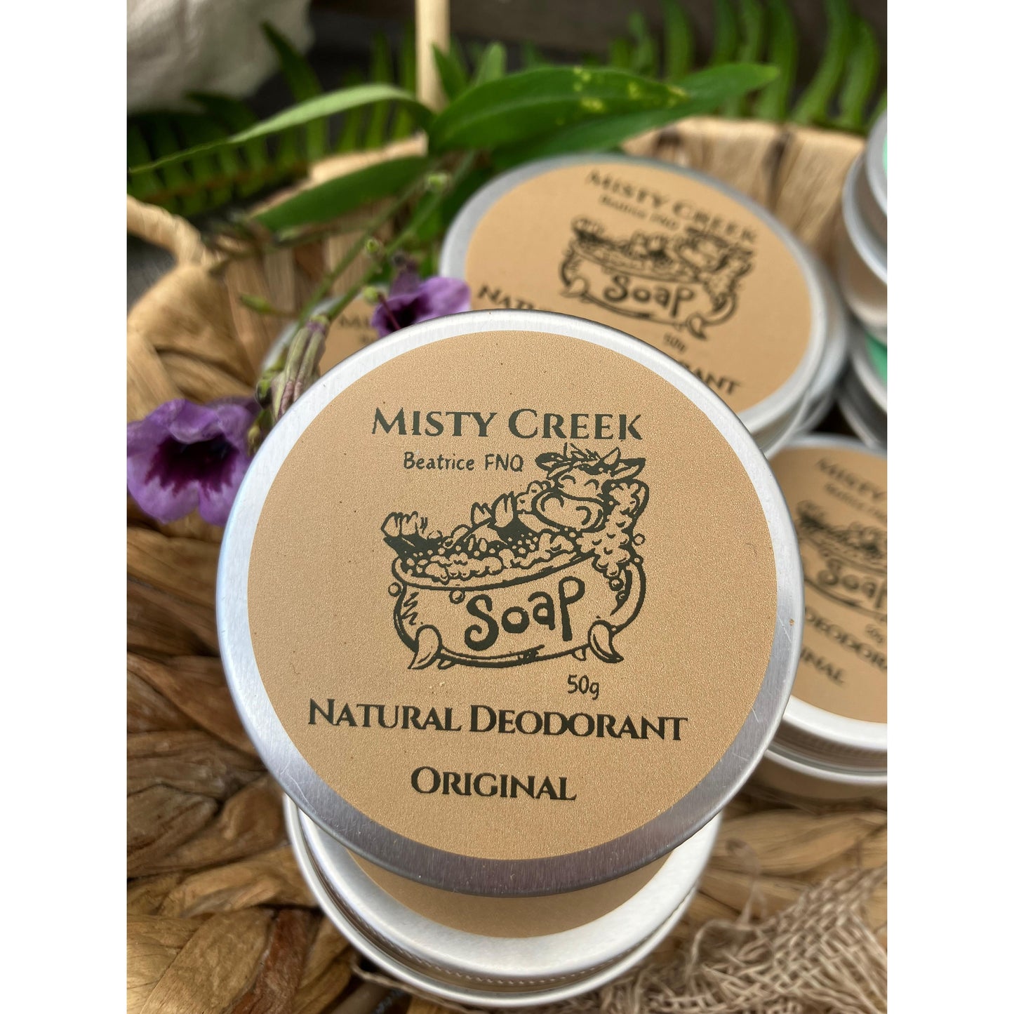 Misty Creek natural deodorant containers with brown labels and silver lids.