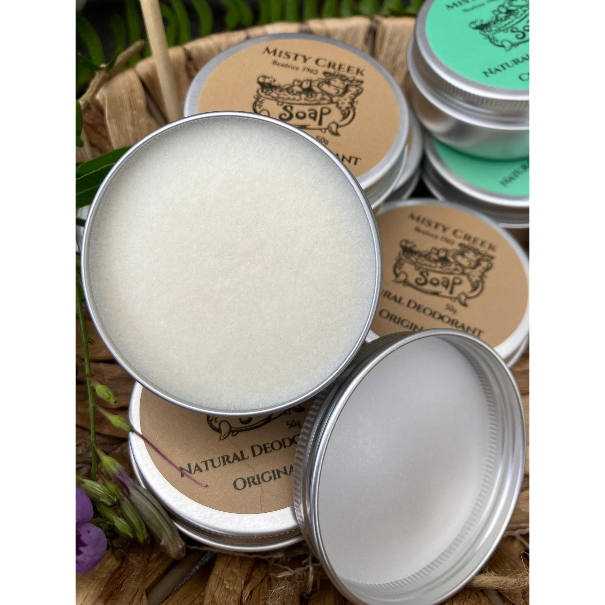 Close-up of metal tins with natural soap products on a rustic background
