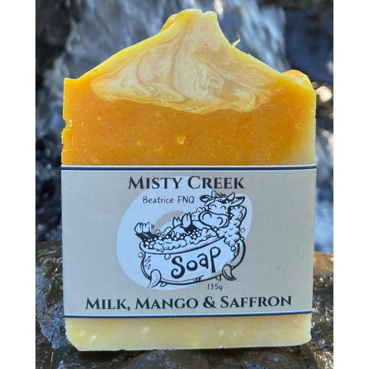 Bar of soap with 'Misty Creek Soap' label on a natural stone background